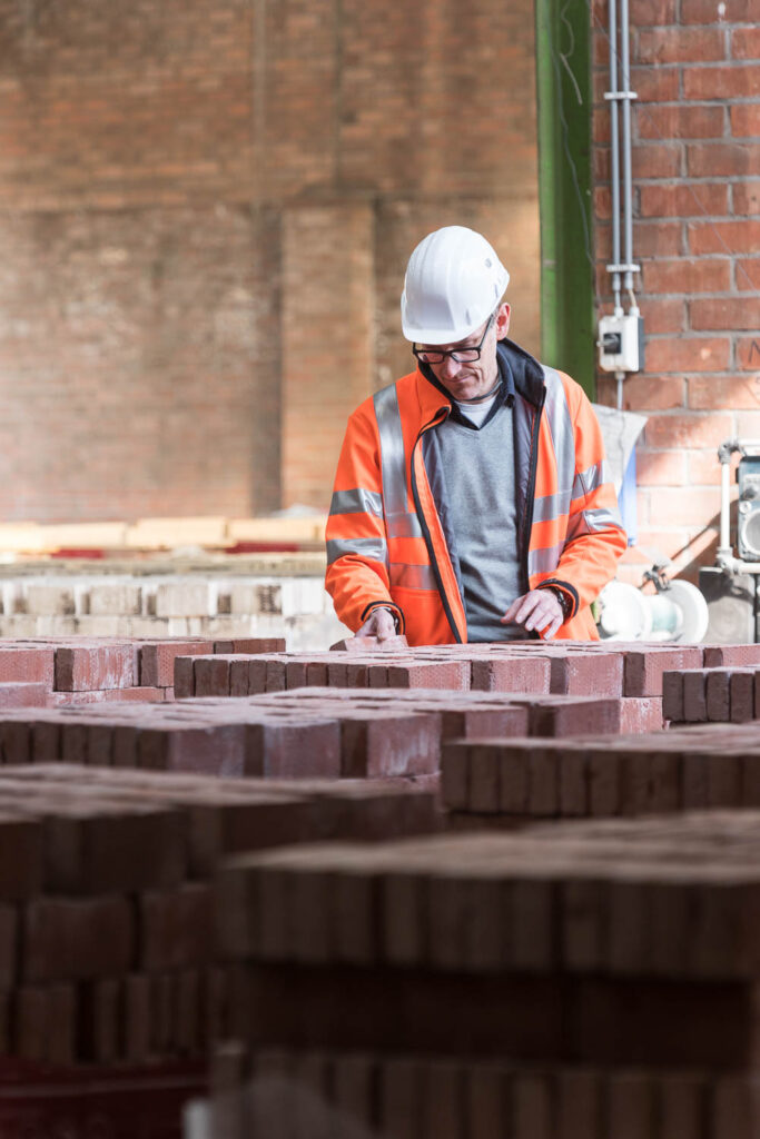 Plant manager inspecting facing bricks